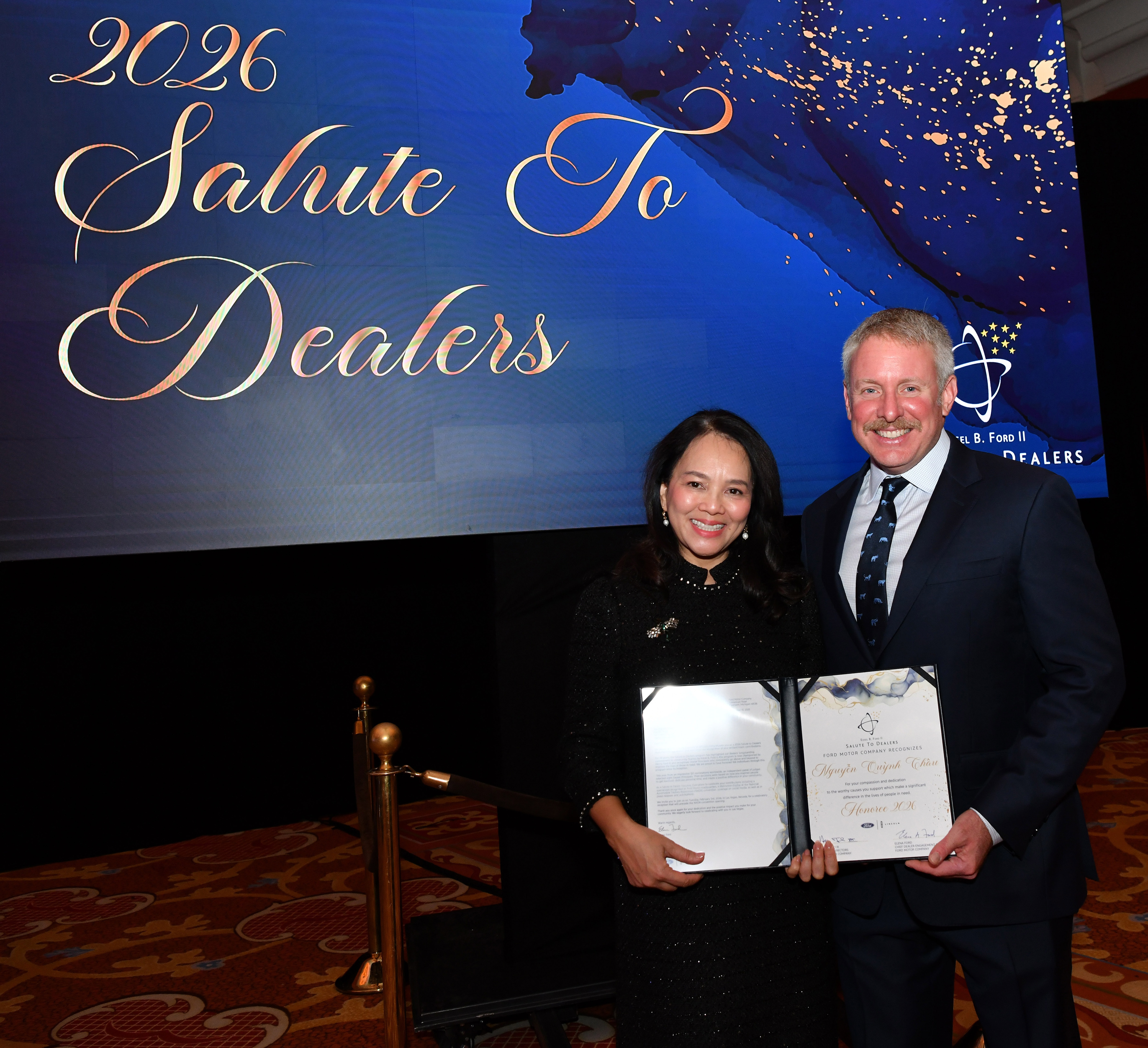 LAS VEGAS,  Feb. 3, 2026 — Henry Ford III recognized the Ford Motor Company 2026 Salute to Dealers honorees at a reception on Feb. 3 in Las Vegas. For the past 26 years, Salute to Dealers, has recognized Dealer Principals who have made an extraordinary commitment to helping their communities through their support of countless charitable and philanthropic causes. This year, eight dealers were honored. Pictured: Henry Ford III and Nguyen Quynh Chau.Photo by: Sam VarnHagen